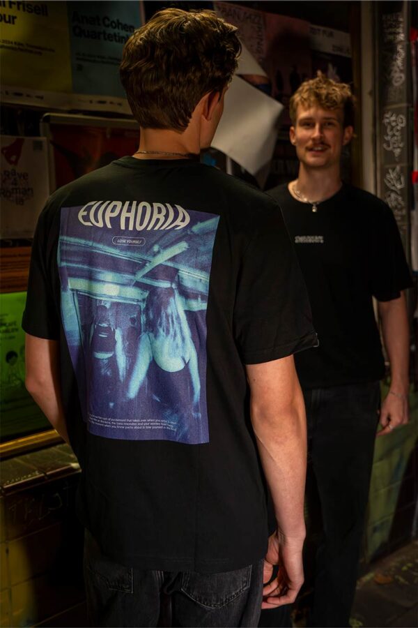 bold backprint of the organic cotton, fairwear Rave Memories Euphoria T-Shirt, worn by DJ collective Parakeet in Cologne